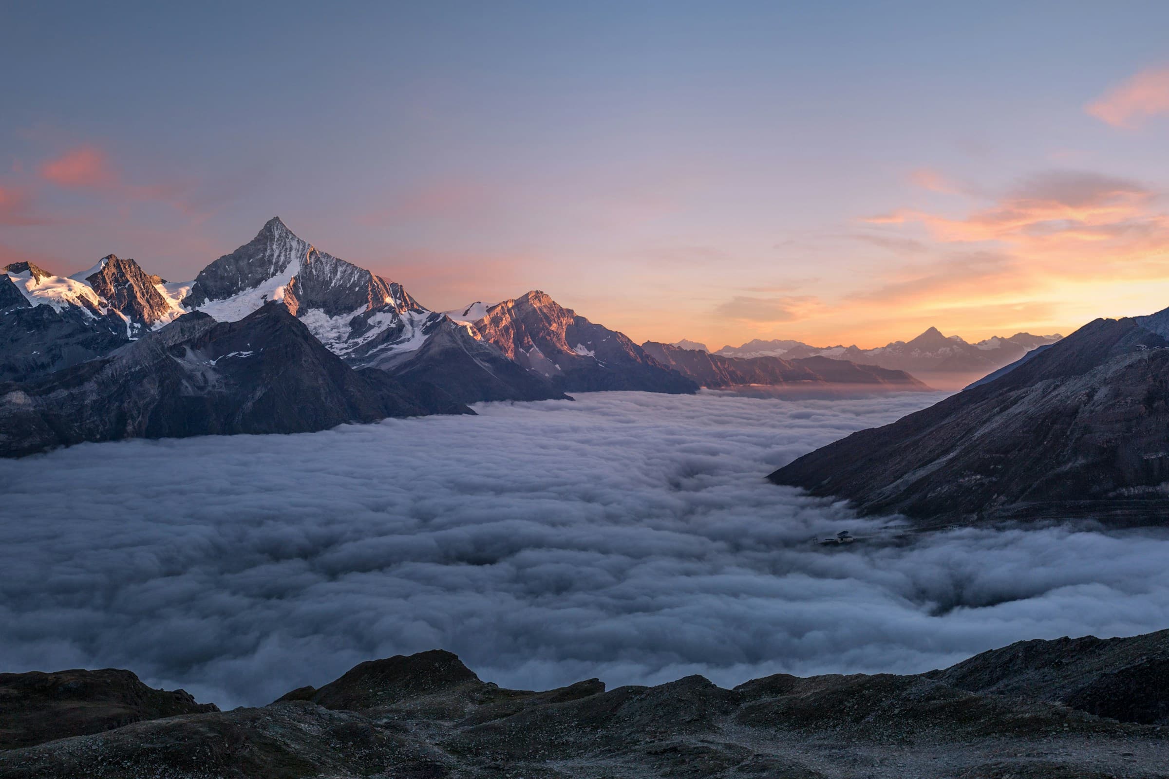 Dramatic mountain landscape at golden hour, open sky and ridgelines.